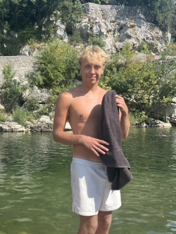 JACKIE standing in a river holding a towel